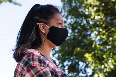 Side portrait of woman wearing face mask