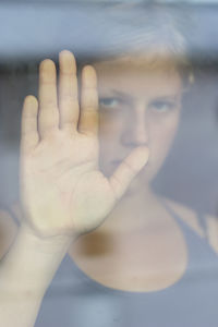 Close-up of girl's hand on glass