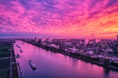 Aerial view of city against sky during sunset