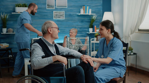 Nurses consoling senior patients in rehab center