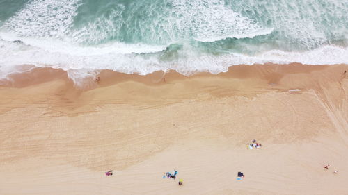 Aerial view of waves against coast