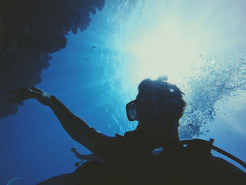 Low angle view of man swimming in sea
