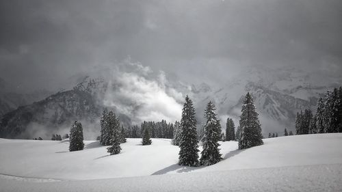 Scenic view of snow covered mountains against sky