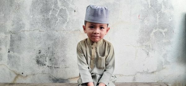 Portrait of boy against wall