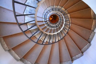 Directly above shot of man seen through spiral staircase