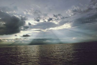 Scenic view of sea against storm clouds