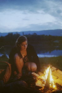 Reflection of man and woman sitting on barbecue grill