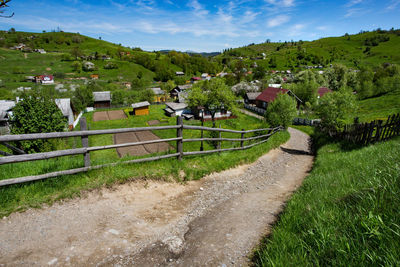 High angle view of houses on field against sky