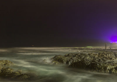 Scenic view of sea against sky at night