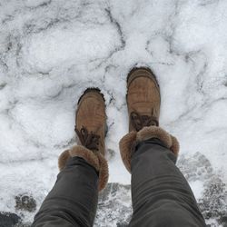 Low section of man standing on snow