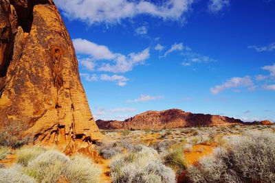 View of rock formations against cloudy sky