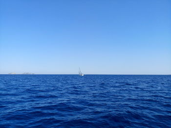 Scenic view of sea against clear blue sky