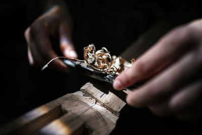 Unrecognized luthier woman in traditional workshop