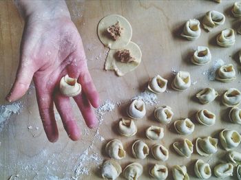 Hand holding raw tortellini