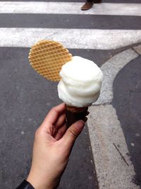 Cropped hand holding ice cream