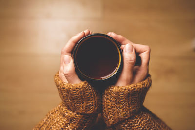 Cropped image of hand holding coffee cup