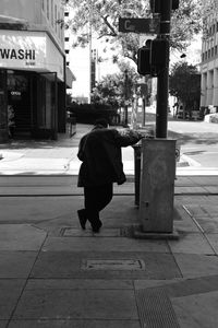 Full length of man on sidewalk in city