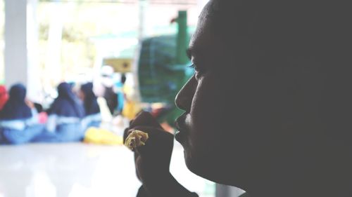 Close-up portrait of a man drinking glass