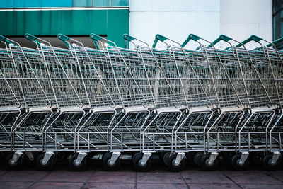 Close-up of shopping carts on footpath