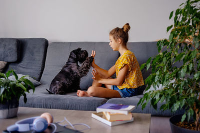 Young woman sitting on sofa at home