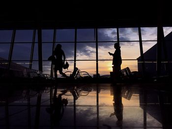 Silhouette women at airport waiting room