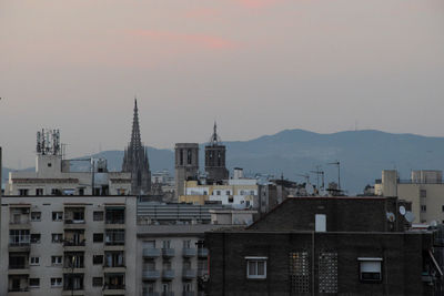 Buildings in city against sky during sunset. poble-sec residential district in barcelona city.