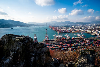 Panoramic view of sea and cityscape against sky