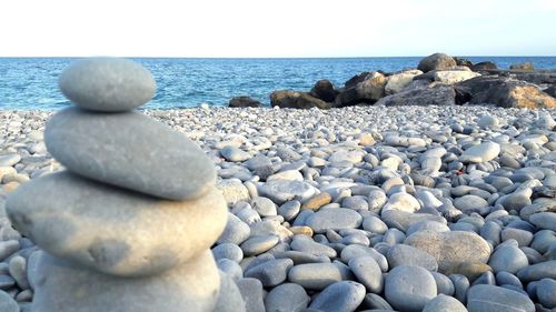 Rocks on beach against sky