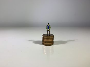 Toy figurine on table against white background