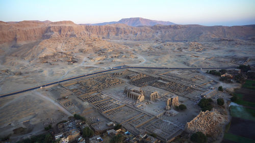 Aerial view medinet habu temple from hot air balloon with valley of the kings skyline luxor egypt