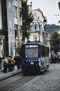 Rear view of people walking on road