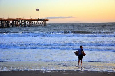 Rear view of man standing on beach