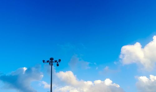 Low angle view of street light against blue sky