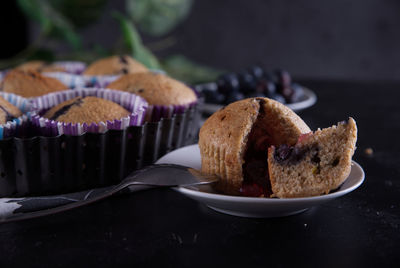 Delicious homemade cupcakes filled with blueberries and presented in small molds.