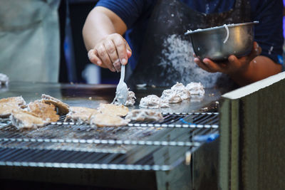 Midsection of person preparing food on table