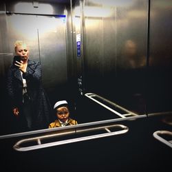 Self portrait of woman and child in elevator