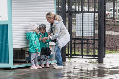 Children standing against wall