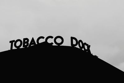 Low angle view of birds sign against clear sky