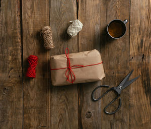 Top view of packing a gift on a wooden table