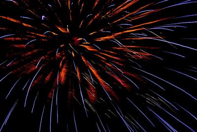 Low angle view of firework display at night