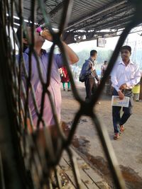 People walking in corridor of man