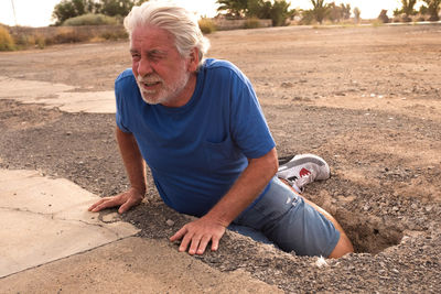 Full length of man sitting on land