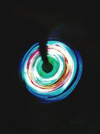 Multi colored light painting against black background