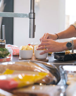 Midsection of woman preparing food in kitchen