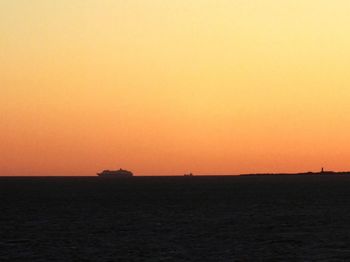 Scenic view of sea against clear sky during sunset