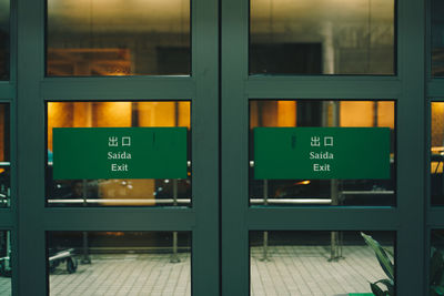 Exit signs on glass doors