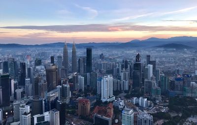 Aerial view of buildings in city during sunset