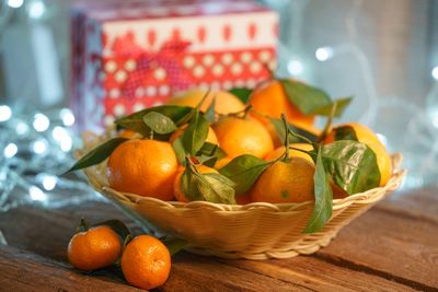 Close-up of orange fruits in basket on table
