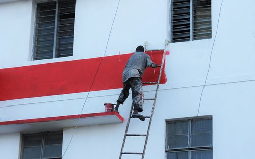 Low angle view of man working on building