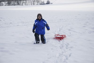 Full length of girl in snow on field